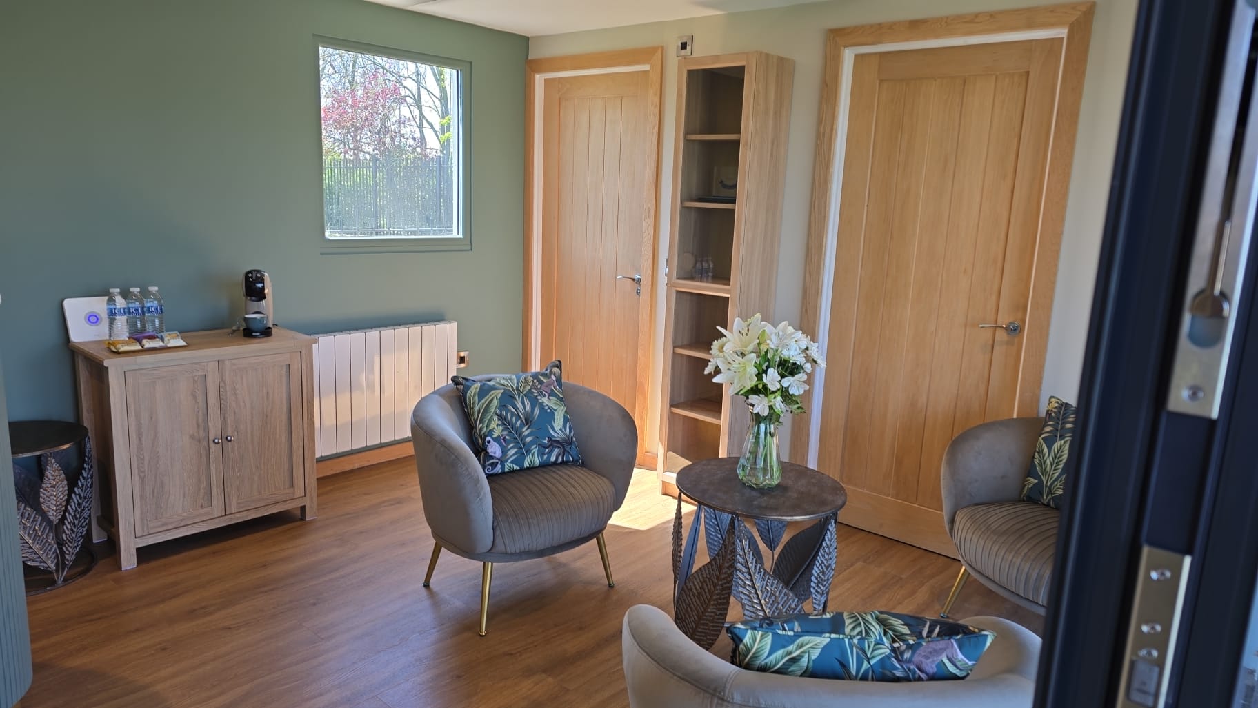 Waiting area with soft seating and fresh flowers
